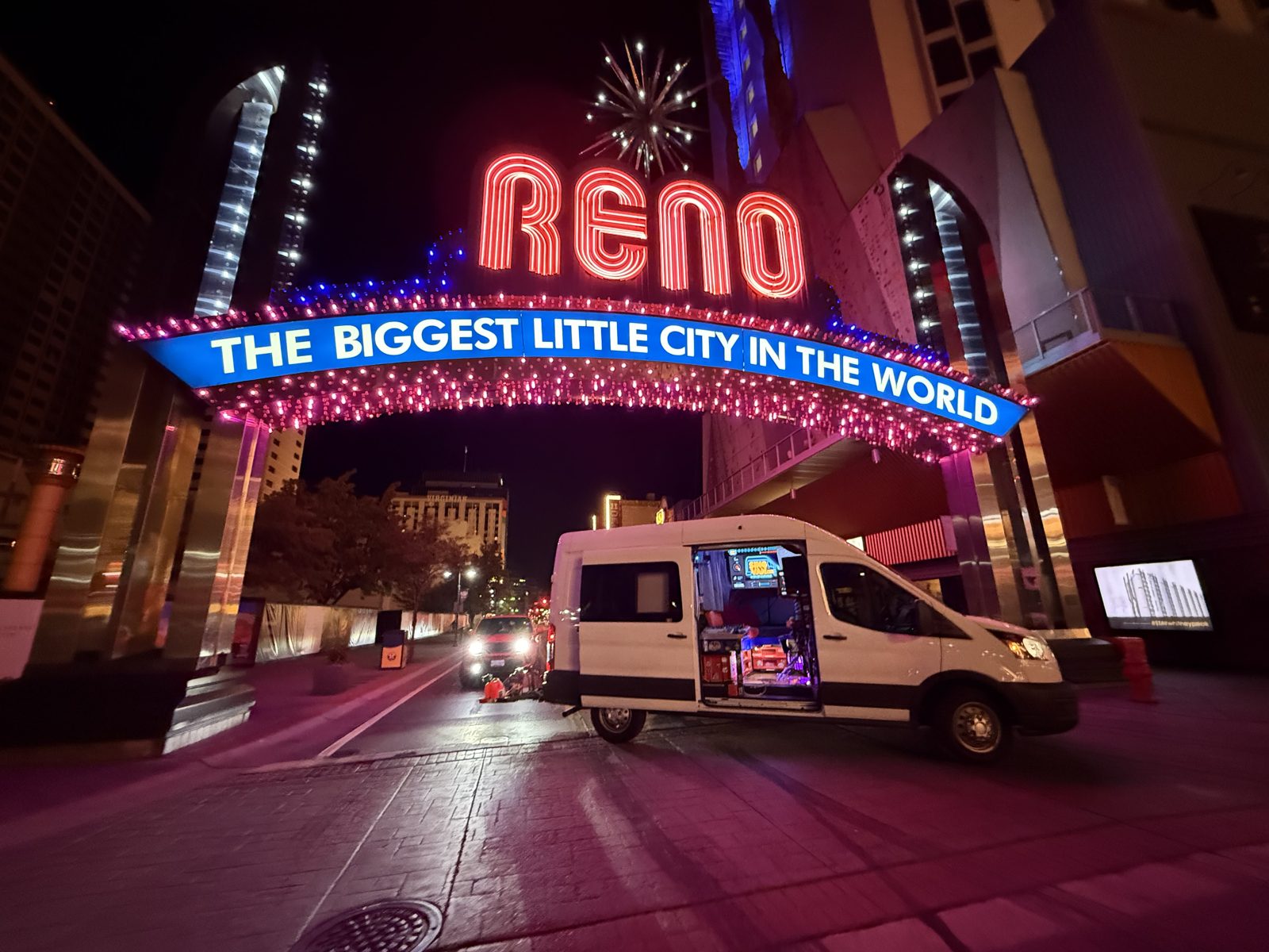 SingVan with its karaoke setup open beneath the illuminated Reno Arch